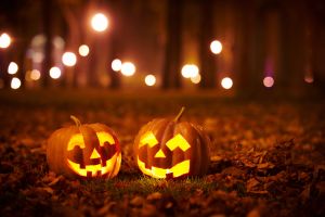 two pumpkins carved into jack-o'-lanterns 
