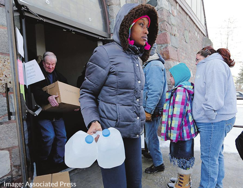 Residents Queue for Free Water Provided By the State in Flint Michigan