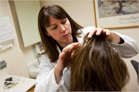 Dermatologist assessing woman's scalp The Belgravia Centre