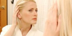 Woman Checking Hair Thinning in Mirror